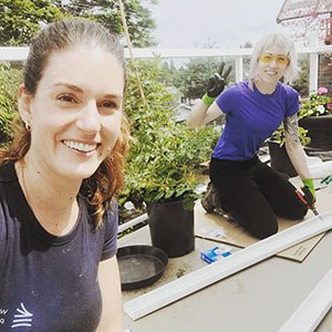 two women working smiling at camera