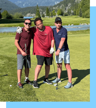 three workers golfing one is wearing a bright red shirt